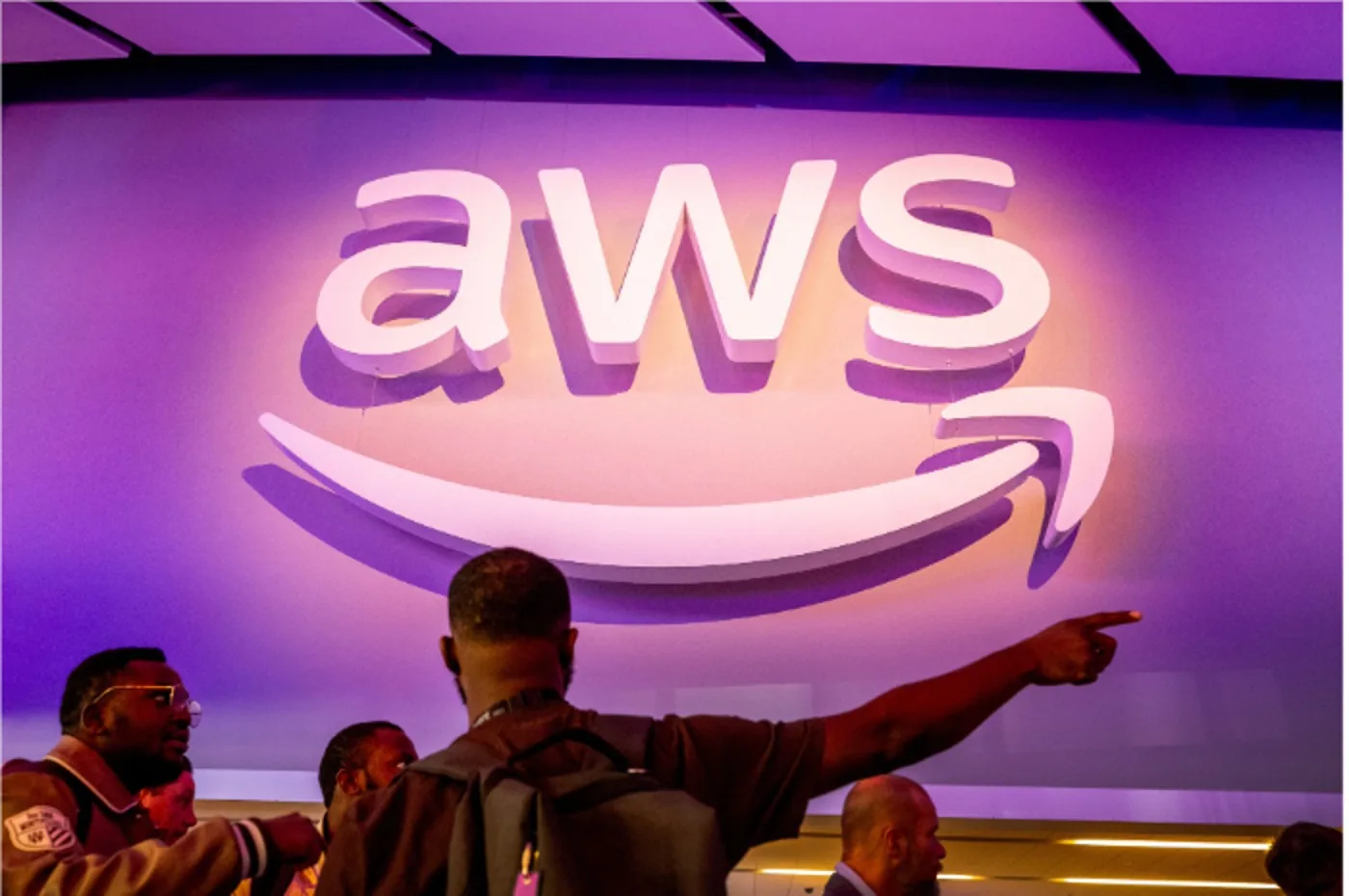 The AWS logo on a purple wall at an Amazon event