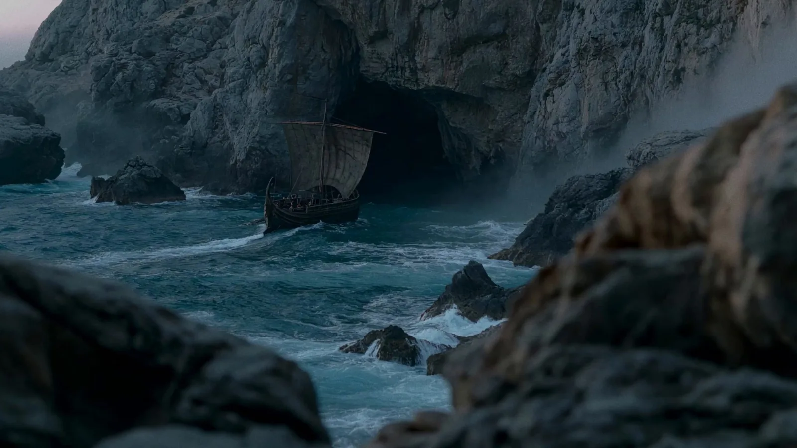 A ship sailing toward a cave in a still from Grok Imagine's Odyssey Episode 1
