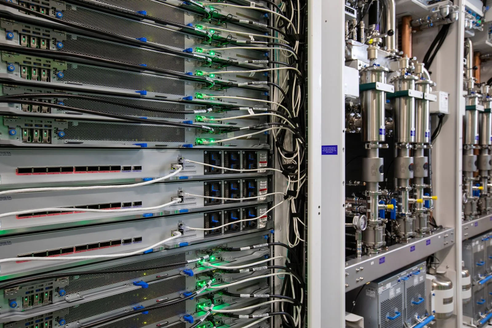 Server rack with network cables and cooling pipes